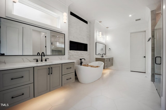 2713 Trifle Ln, Wake Forest, NC 27587 - bathroom featuring a shower stall, two vanities, and a freestanding tub