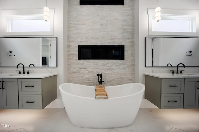 2713 Trifle Ln, Wake Forest, NC 27587 - full bathroom featuring two vanities, a freestanding tub, and tile patterned floors