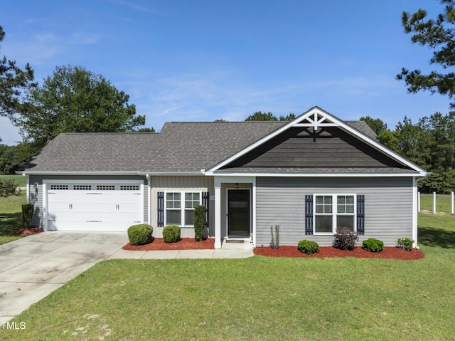 101 Rolling Knoll Ct, Dudley, NC 28333 - view of front of house featuring an attached garage, driveway, a front yard, and roof with shingles