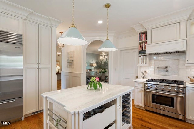 801 Pinehurst Dr, Chapel Hill, NC 27517 - kitchen featuring high end appliances, backsplash, wood finished floors, pendant lighting, and light stone countertops