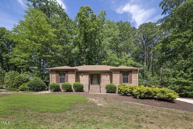 136 Sycamore St, Cary, NC 27513 - view of front facade featuring a front yard and brick siding