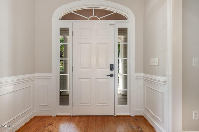 124 Cypress View Way, Apex, NC 27502 - entrance foyer featuring light wood-style floors, a decorative wall, and wainscoting