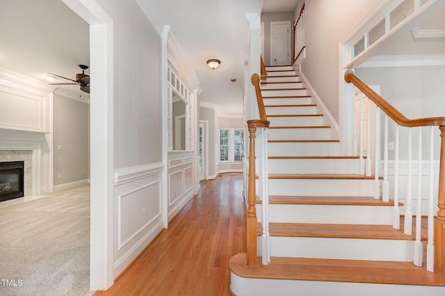 124 Cypress View Way, Apex, NC 27502 - stairs with ceiling fan, ornamental molding, a fireplace, wood finished floors, and baseboards