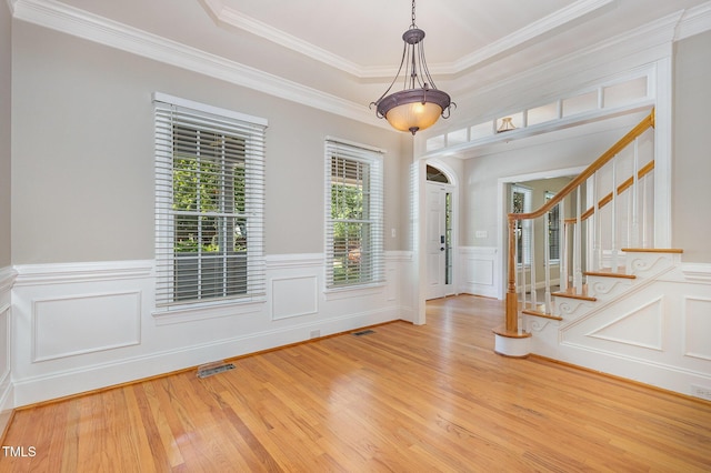 124 Cypress View Way, Apex, NC 27502 - entryway with healthy amount of natural light, crown molding, wood finished floors, stairs, and wainscoting
