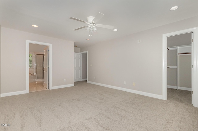 124 Cypress View Way, Apex, NC 27502 - unfurnished bedroom featuring light carpet, recessed lighting, a walk in closet, baseboards, and ceiling fan