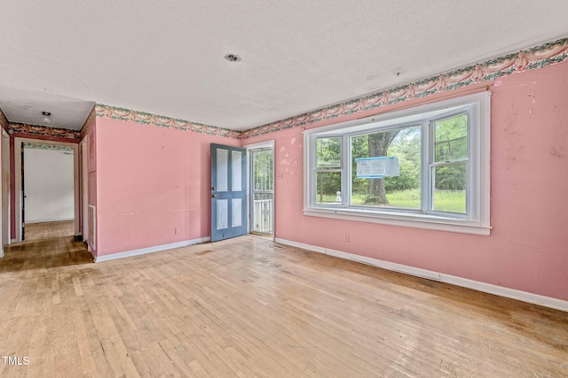 211 Cool Spring Rd, Durham, NC 27713 - unfurnished room with light wood-type flooring, baseboards, and a textured ceiling