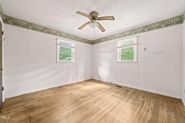 211 Cool Spring Rd, Durham, NC 27713 - spare room with plenty of natural light, hardwood / wood-style flooring, a ceiling fan, and a textured ceiling