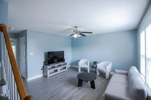 1806 Stroll Cir, Fuquay Varina, NC 27526 - living room with a textured ceiling, wood finished floors, baseboards, and a ceiling fan