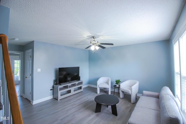 1806 Stroll Cir, Fuquay Varina, NC 27526 - living area with a textured ceiling, plenty of natural light, wood finished floors, baseboards, and a ceiling fan