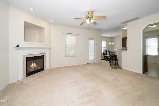 4009 Patriot Ridge Ct, Raleigh, NC 27610 - living room featuring carpet, ceiling fan, a premium fireplace, baseboards, and arched walkways