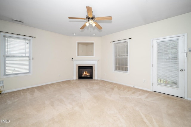 4009 Patriot Ridge Ct, Raleigh, NC 27610 - unfurnished living room featuring baseboards, carpet floors, ceiling fan, and a fireplace with flush hearth