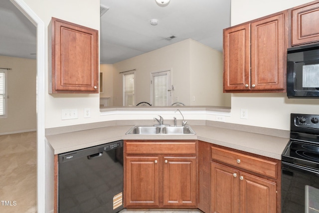 4009 Patriot Ridge Ct, Raleigh, NC 27610 - kitchen featuring black appliances, a sink, light countertops, and brown cabinets