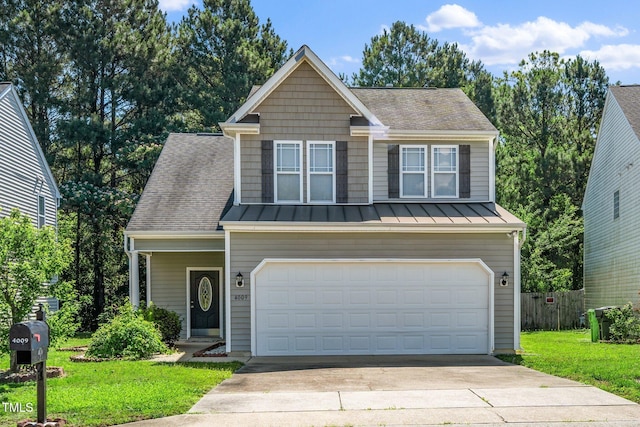 4009 Patriot Ridge Ct, Raleigh, NC 27610 - view of front facade featuring driveway, an attached garage, a standing seam roof, and roof with shingles
