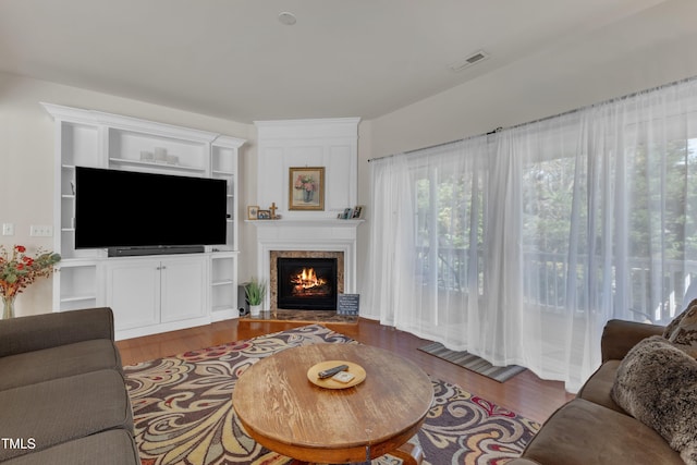3400 Secretariat Way, Raleigh, NC 27614 - living area featuring a lit fireplace and wood finished floors