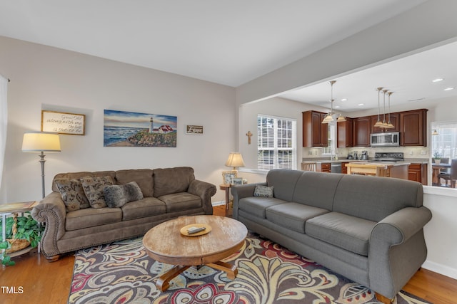 3400 Secretariat Way, Raleigh, NC 27614 - living room featuring light wood finished floors, baseboards, and recessed lighting