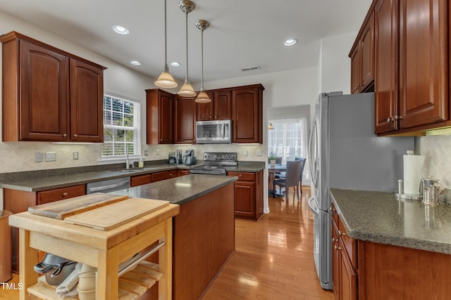 3400 Secretariat Way, Raleigh, NC 27614 - kitchen with appliances with stainless steel finishes, light wood finished floors, a sink, tasteful backsplash, and recessed lighting