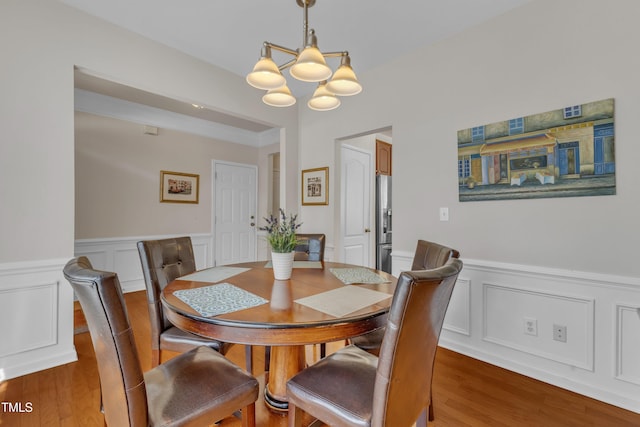 3400 Secretariat Way, Raleigh, NC 27614 - dining room featuring a chandelier, a decorative wall, wainscoting, and wood finished floors