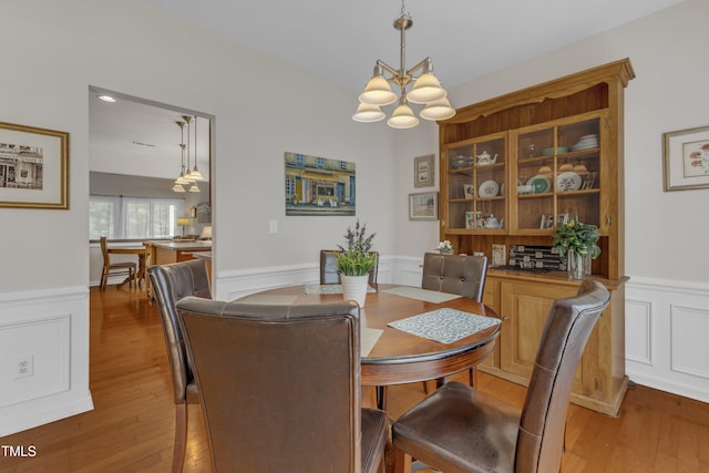 3400 Secretariat Way, Raleigh, NC 27614 - dining area with wainscoting, a chandelier, hardwood / wood-style floors, and a decorative wall