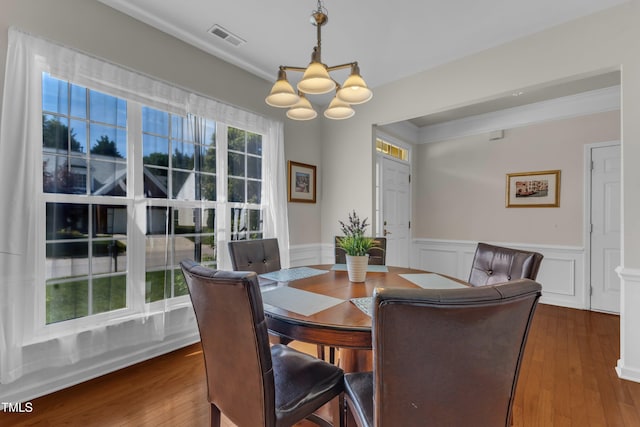 3400 Secretariat Way, Raleigh, NC 27614 - dining area featuring a chandelier, a wainscoted wall, and dark wood finished floors