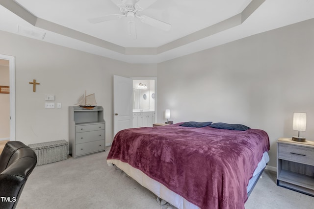 3400 Secretariat Way, Raleigh, NC 27614 - carpeted bedroom featuring a tray ceiling, connected bathroom, a ceiling fan, and baseboards