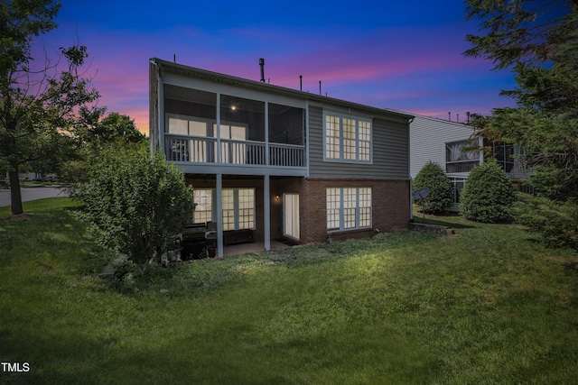 3400 Secretariat Way, Raleigh, NC 27614 - back of house with a yard, a sunroom, brick siding, a patio, and french doors