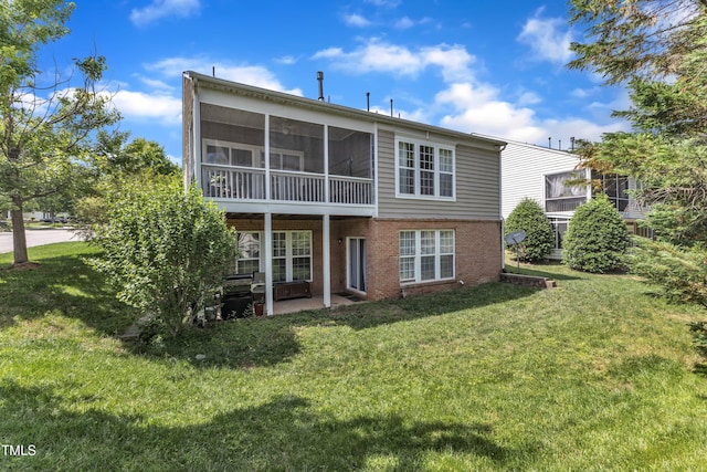 3400 Secretariat Way, Raleigh, NC 27614 - back of property featuring a lawn, brick siding, a sunroom, and a patio