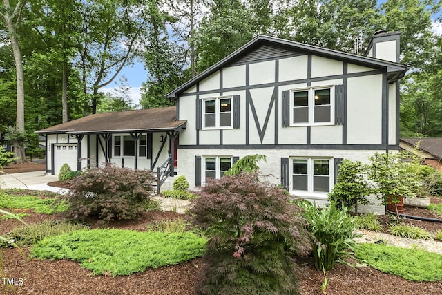1420 Seabrook Ave, Cary, NC 27511 - view of front of house with a chimney, a garage, and concrete driveway