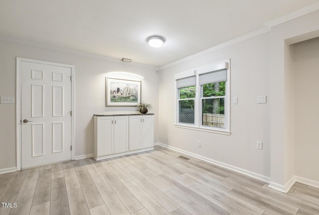 1420 Seabrook Ave, Cary, NC 27511 - unfurnished dining area with crown molding, light wood finished floors, and baseboards