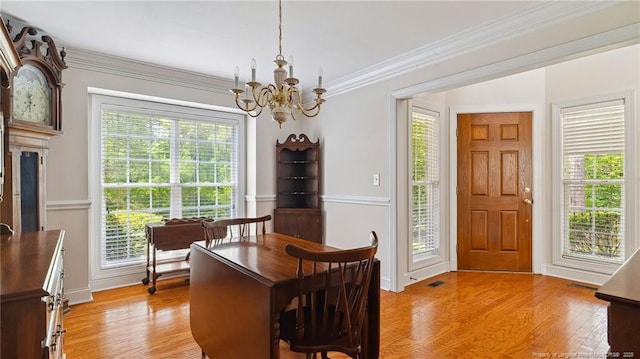 202 Juniper Creek Blvd, Pinehurst, NC 28374 - dining space with a chandelier, light wood-style floors, baseboards, and ornamental molding