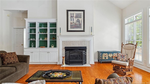202 Juniper Creek Blvd, Pinehurst, NC 28374 - living area with wood finished floors, healthy amount of natural light, a tile fireplace, and lofted ceiling