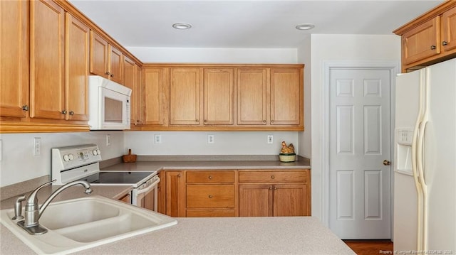 202 Juniper Creek Blvd, Pinehurst, NC 28374 - kitchen with white appliances, a sink, brown cabinets, light countertops, and recessed lighting