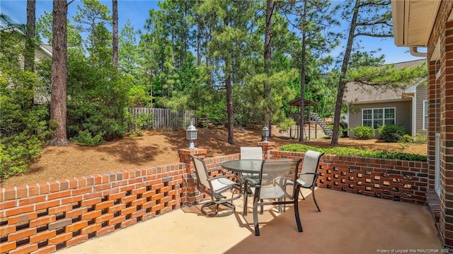 202 Juniper Creek Blvd, Pinehurst, NC 28374 - view of patio / terrace featuring outdoor dining area and a playground