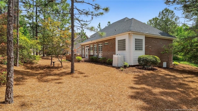 202 Juniper Creek Blvd, Pinehurst, NC 28374 - view of home's exterior featuring brick siding and roof with shingles