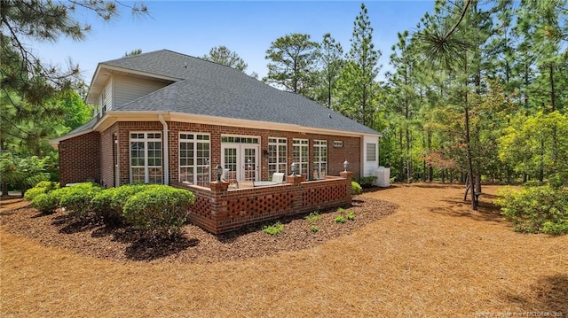 202 Juniper Creek Blvd, Pinehurst, NC 28374 - back of property featuring brick siding, roof with shingles, and french doors