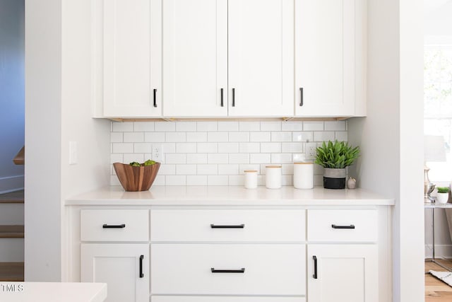 1514 W Knox St, Durham, NC 27705 - kitchen with decorative backsplash, white cabinetry, and light countertops