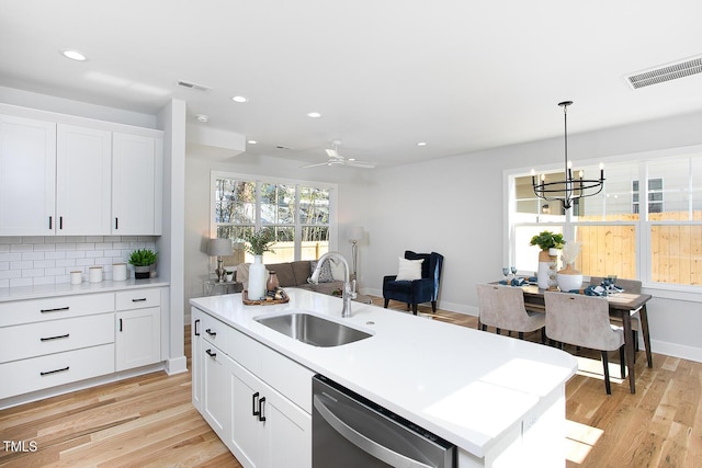 1514 W Knox St, Durham, NC 27705 - kitchen with a sink, dishwasher, light wood finished floors, light countertops, and a chandelier