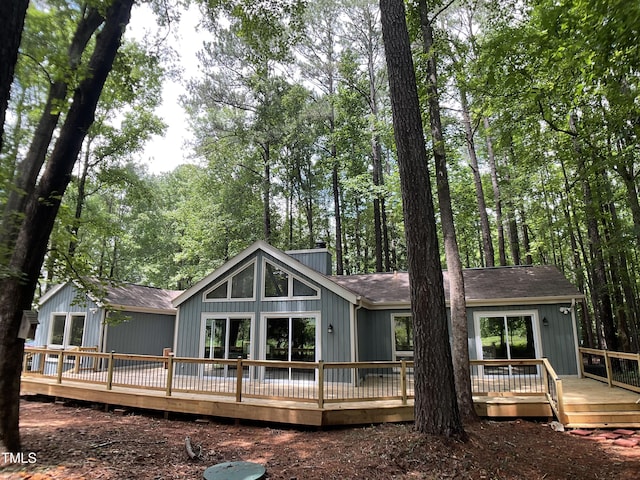 102 Pebble Ct, Chapel Hill, NC 27516 - back of property with a deck, a chimney, and a shingled roof