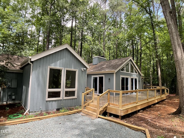 102 Pebble Ct, Chapel Hill, NC 27516 - back of house featuring a wooden deck, roof with shingles, and a chimney