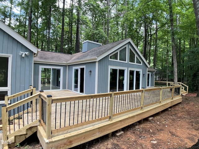 102 Pebble Ct, Chapel Hill, NC 27516 - back of house featuring a shingled roof, a chimney, and a deck