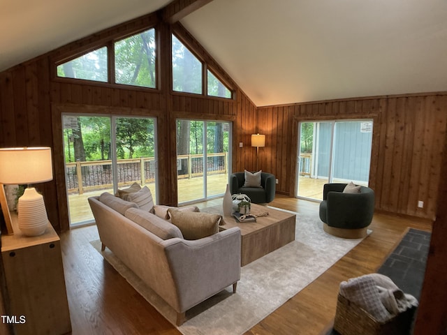 102 Pebble Ct, Chapel Hill, NC 27516 - living area with vaulted ceiling, wooden walls, and wood finished floors
