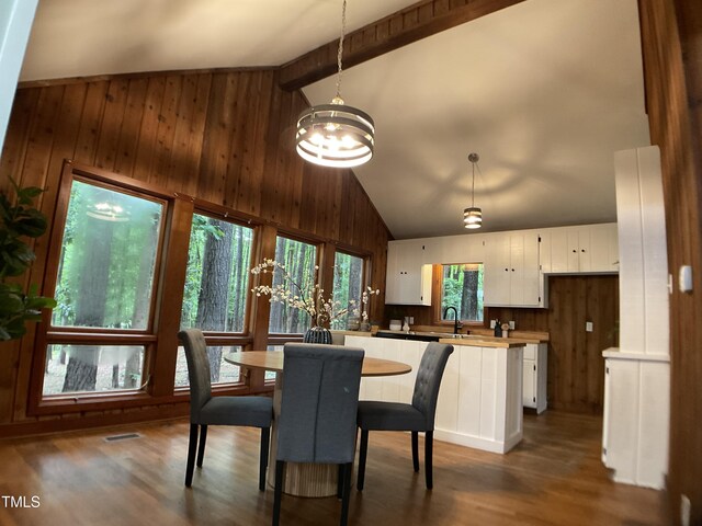 102 Pebble Ct, Chapel Hill, NC 27516 - dining space with wooden walls, high vaulted ceiling, a chandelier, wood finished floors, and beamed ceiling