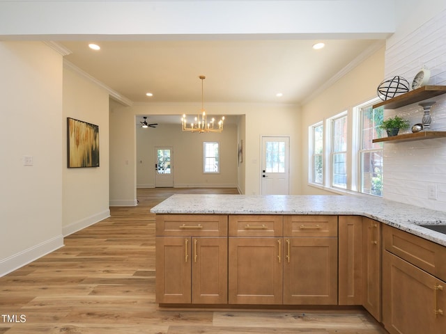 2106 University Dr, Durham, NC 27707 - kitchen with a chandelier, a peninsula, open shelves, ornamental molding, and light stone countertops