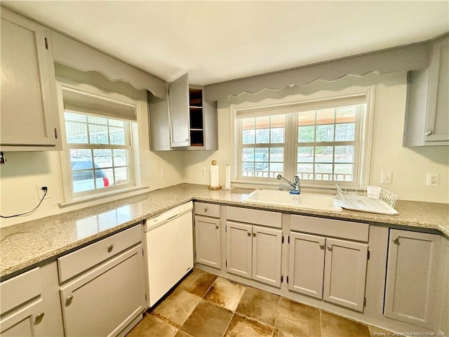 5089 Tobacco Rd, Orrum, NC 28369 - kitchen featuring dishwasher, a sink, light stone counters, and stone finish floors