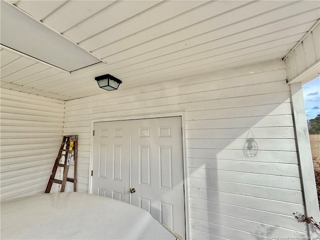 5089 Tobacco Rd, Orrum, NC 28369 - bedroom featuring wooden walls and a closet
