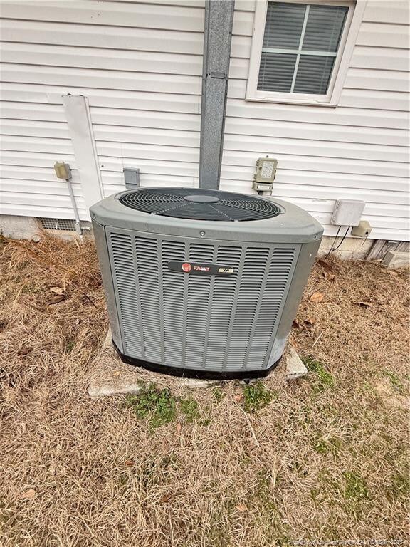 5089 Tobacco Rd, Orrum, NC 28369 - exterior view of central AC unit and crawl space