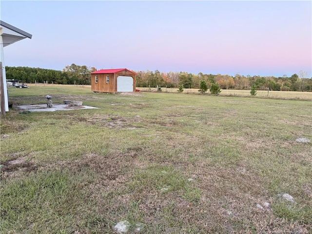 5089 Tobacco Rd, Orrum, NC 28369 - view of grassy yard featuring an outdoor structure and a garage