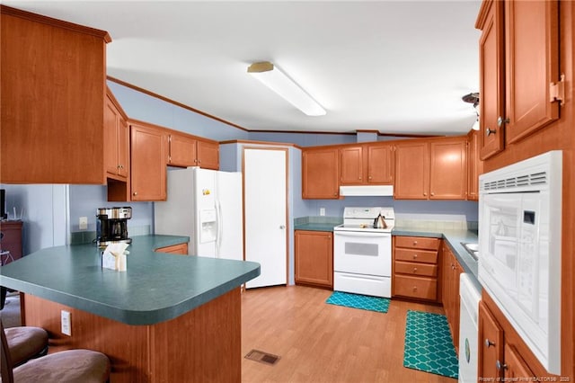 7504 Hidden Ln, Roseboro, NC 28382 - kitchen featuring white appliances, a peninsula, under cabinet range hood, light wood finished floors, and a breakfast bar area