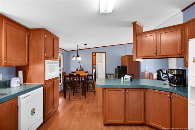 7504 Hidden Ln, Roseboro, NC 28382 - kitchen featuring white appliances, a peninsula, brown cabinets, light wood-style floors, and dark countertops