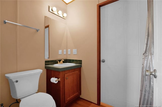 7504 Hidden Ln, Roseboro, NC 28382 - bathroom with vanity, toilet, and wood finished floors