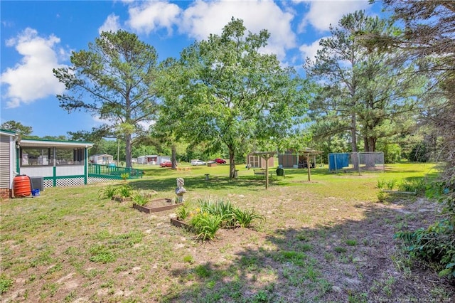 7504 Hidden Ln, Roseboro, NC 28382 - view of yard with a sunroom and a vegetable garden